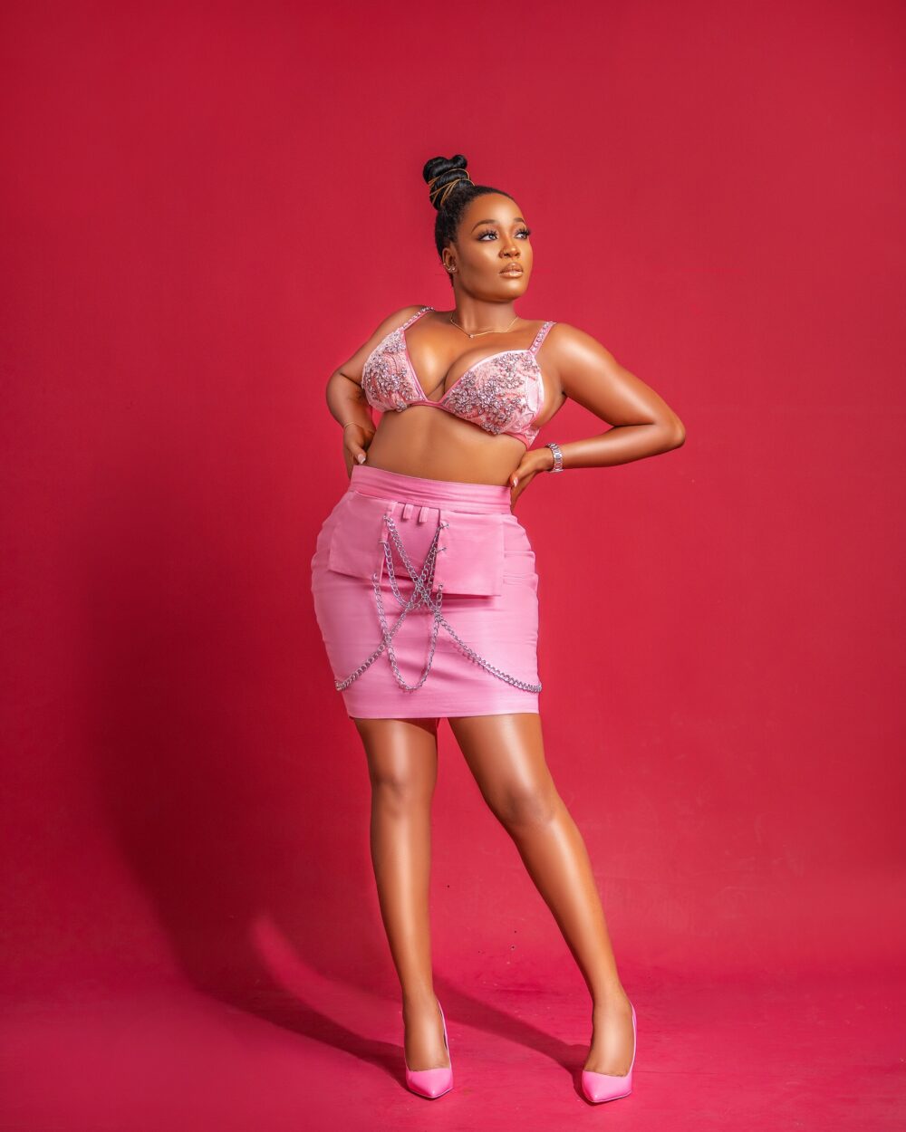 Add a pop of color to your wardrobe with our vibrant pink Chinos chain linked mini skirt, featuring a comfortable fit and edgy chain-link design. Perfect for women who dare to be different and want to make a statement.
